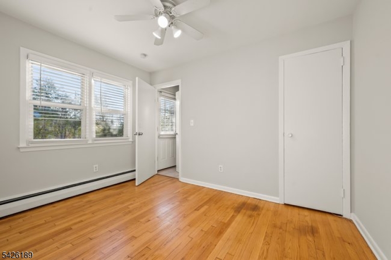 47 River Road Chatham, NJ 07928 - Photo 10 of 21 a view of an empty room with wooden floor and a window