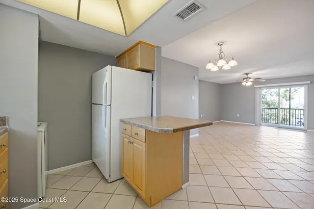 a view of a kitchen with furniture and chandelier