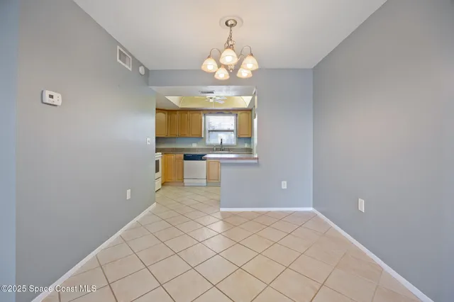 a view of a kitchen with wooden floor and a chandelier