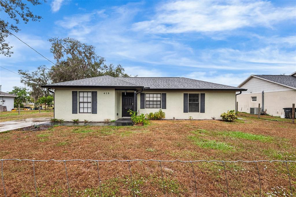 418 Hancock Road Wauchula, FL 33873 - Photo 1 of 1 a front view of a house with a garden and yard