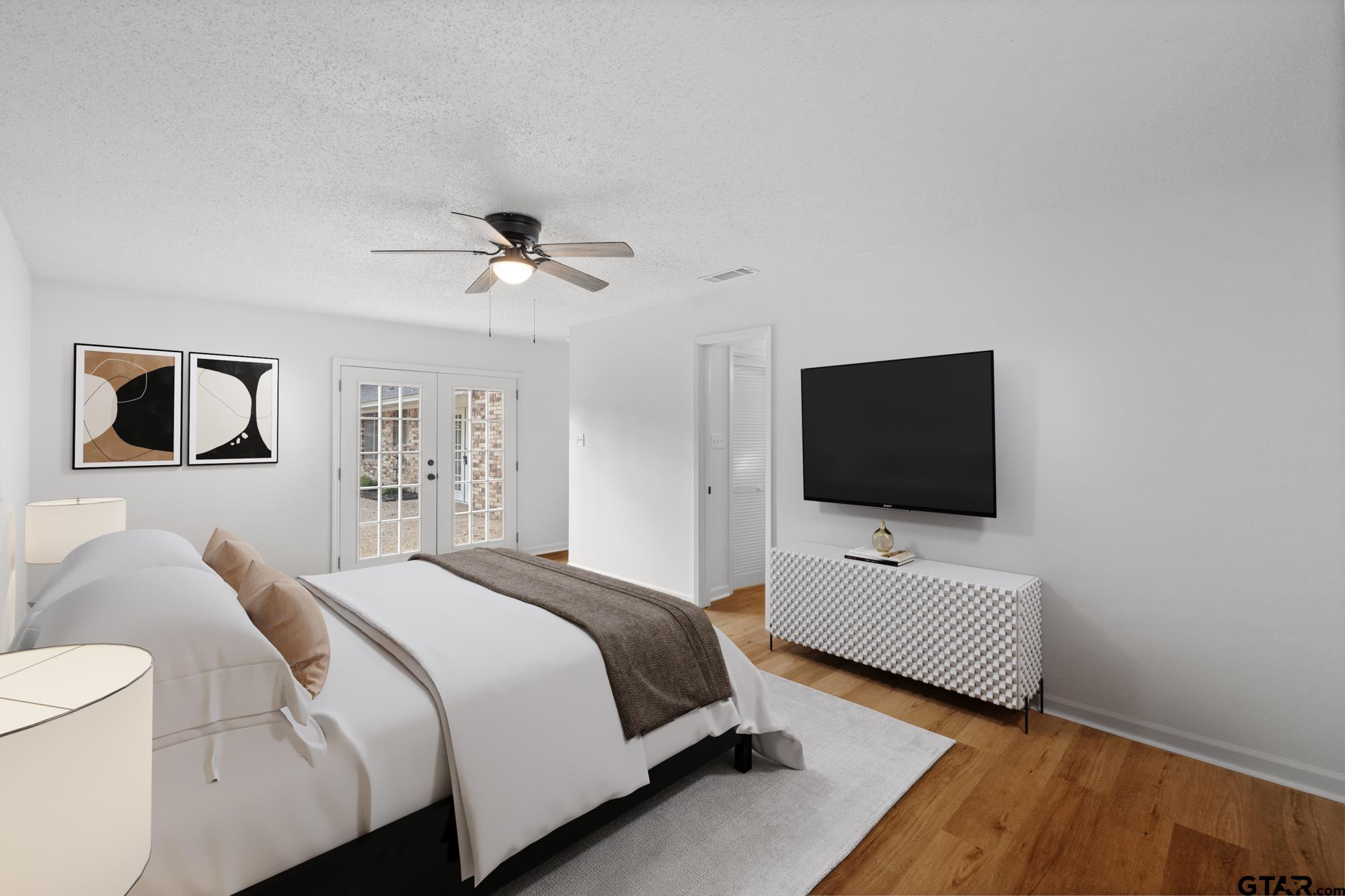 810 Pineland Lane Lindale, TX 75771 - Photo 24 of 42 a bedroom with a bed and a flat screen tv