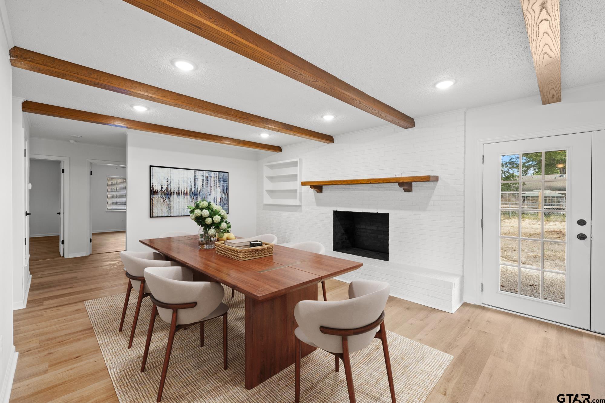 810 Pineland Lane Lindale, TX 75771 - Photo 7 of 42 a view of a dining room with furniture and a fireplace