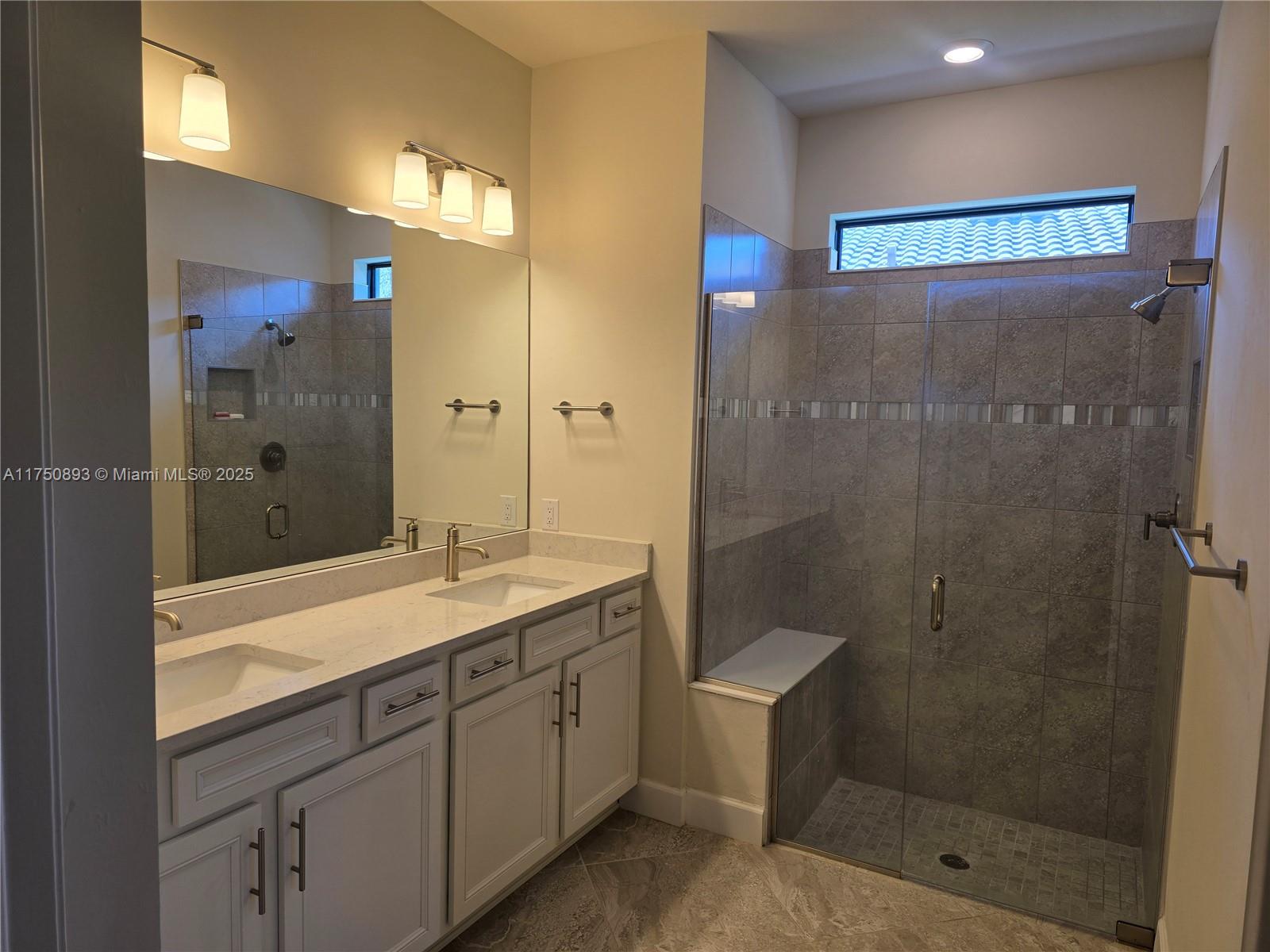 Ave Maria Immokalee, FL 34142 - Photo 11 of 21 a spacious bathroom with a shower sink and mirror