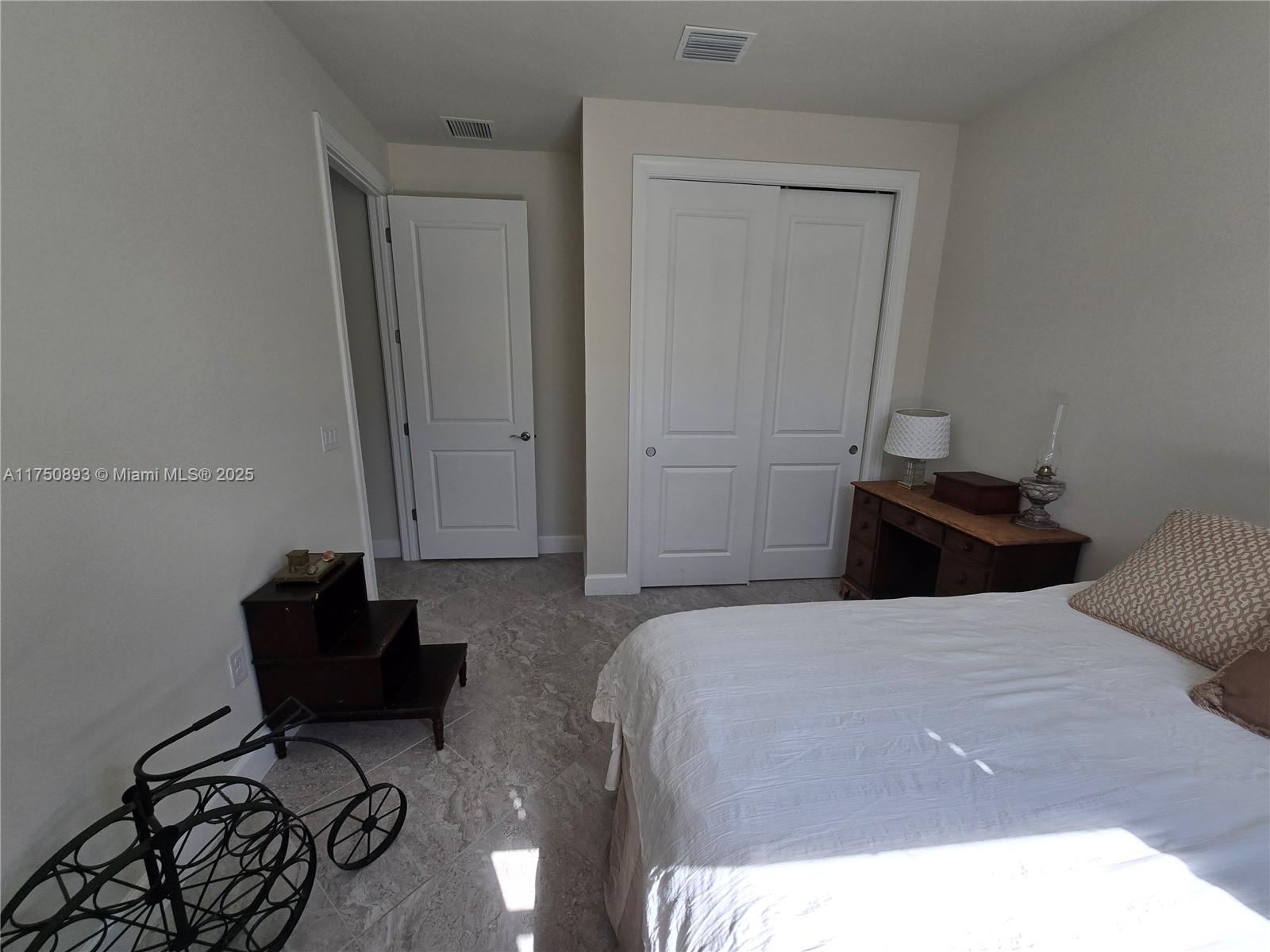 Ave Maria Immokalee, FL 34142 - Photo 14 of 21 a bedroom with a bed and a mirror