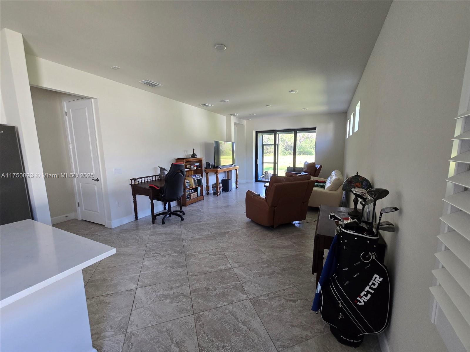 Ave Maria Immokalee, FL 34142 - Photo 5 of 21 a living room with furniture and a chandelier