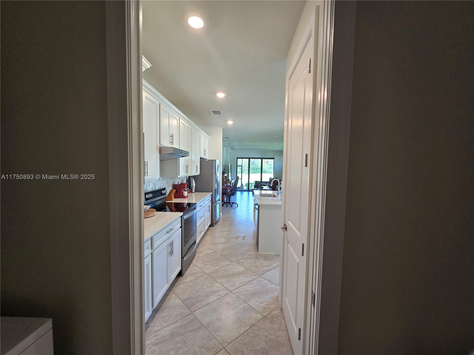 Ave Maria Immokalee, FL 34142 - Photo 6 of 21 a view of a kitchen from the hallway