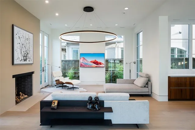 a living room with furniture a fireplace and a large window