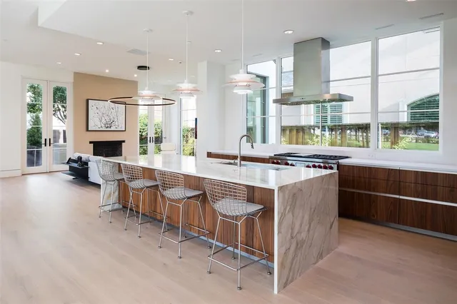 a large kitchen with kitchen island granite countertop a large counter top and stainless steel appliances