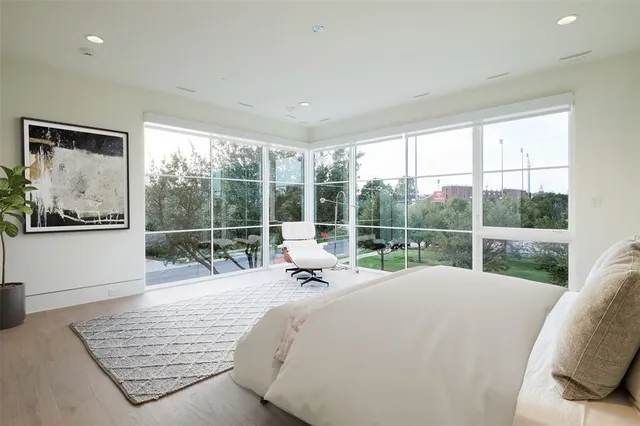 a bed sitting in a bedroom next to a window