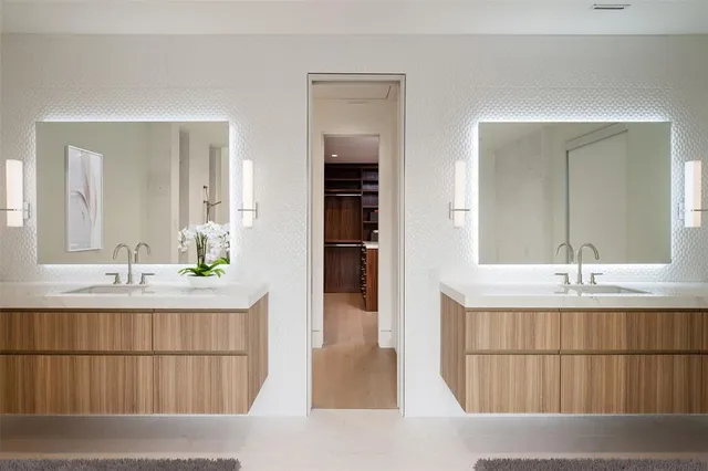 a bathroom with a double vanity sink and a mirror