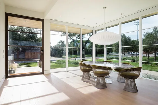 a room with pool table and glass windows