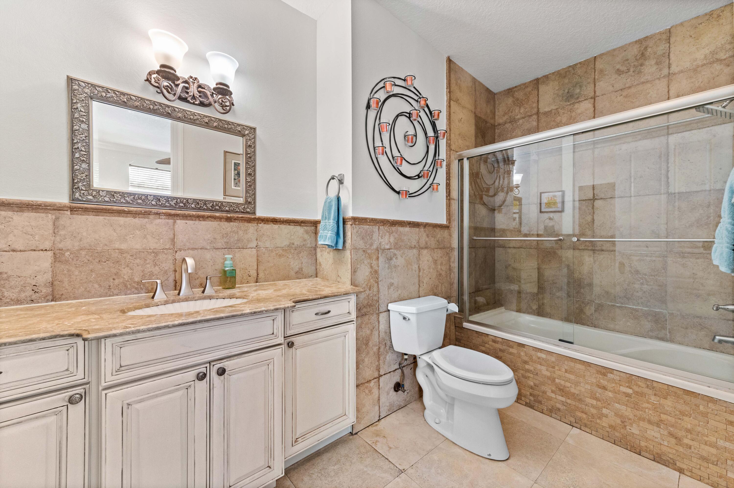 746 West Palmetto Park Road Boca Raton, FL 33486 - Photo 28 of 60 a bathroom with a toilet sink and mirror