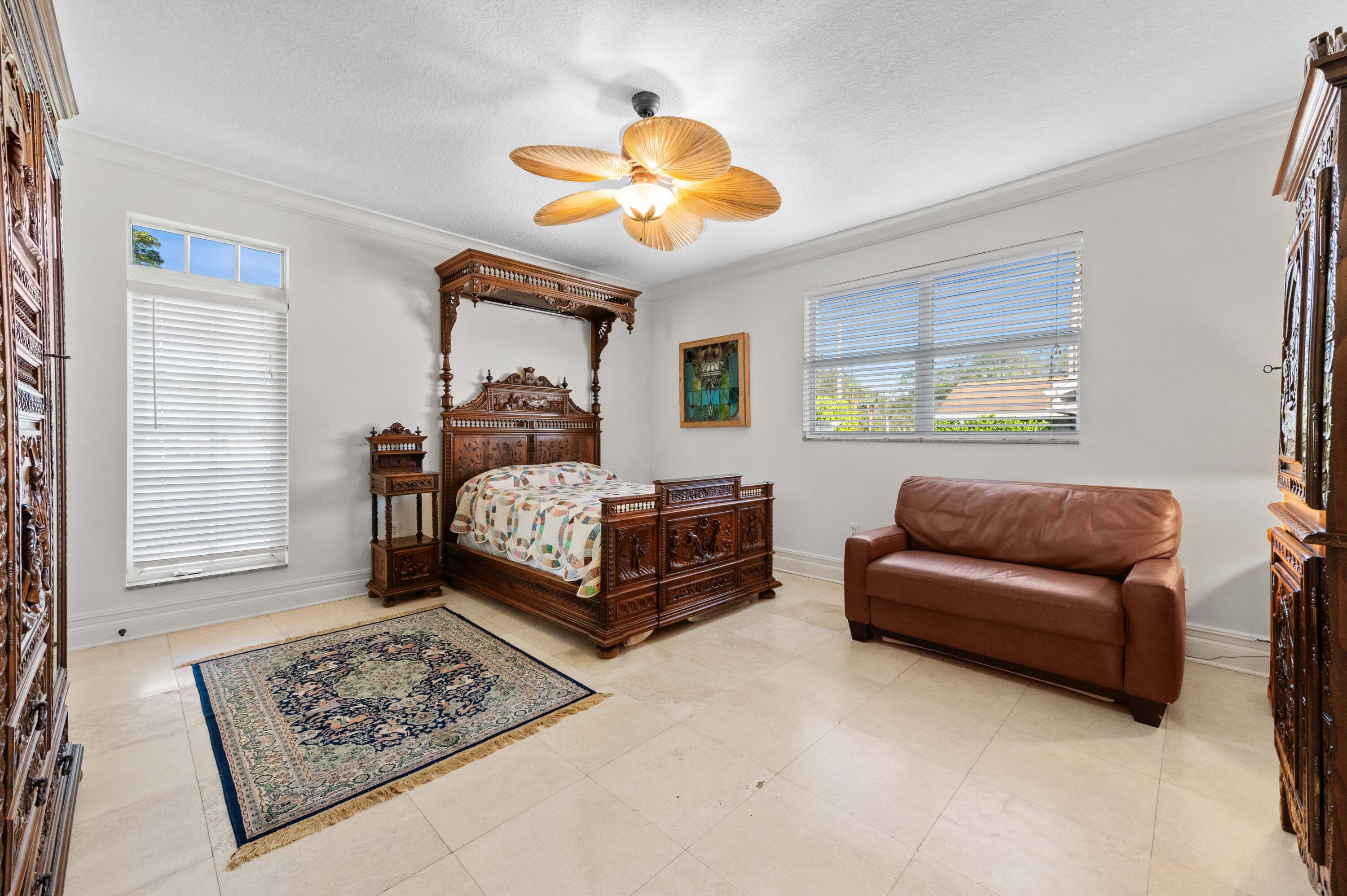 746 West Palmetto Park Road Boca Raton, FL 33486 - Photo 36 of 60 a bedroom with a bed and a chandelier