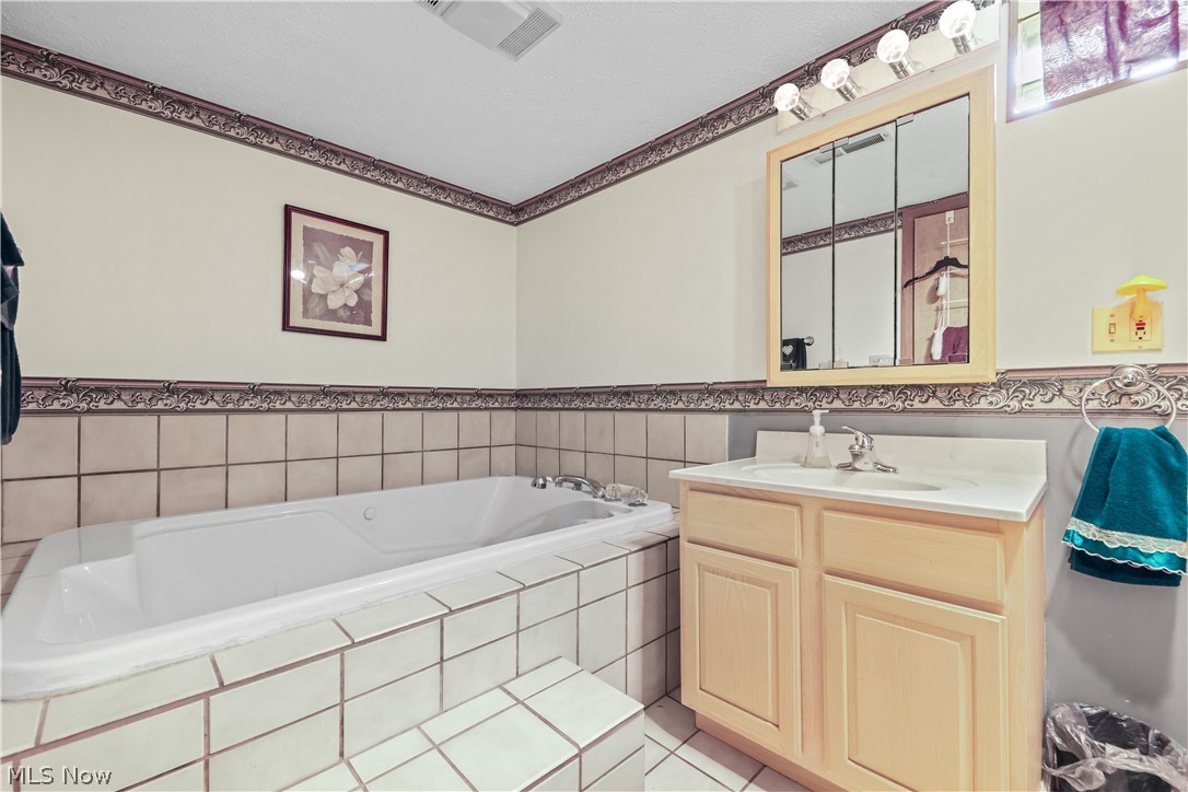 1835 Lynn Road Kent, OH 44240 - Photo 25 of 48 White tiled tub surround featuring a built-in jetted tub