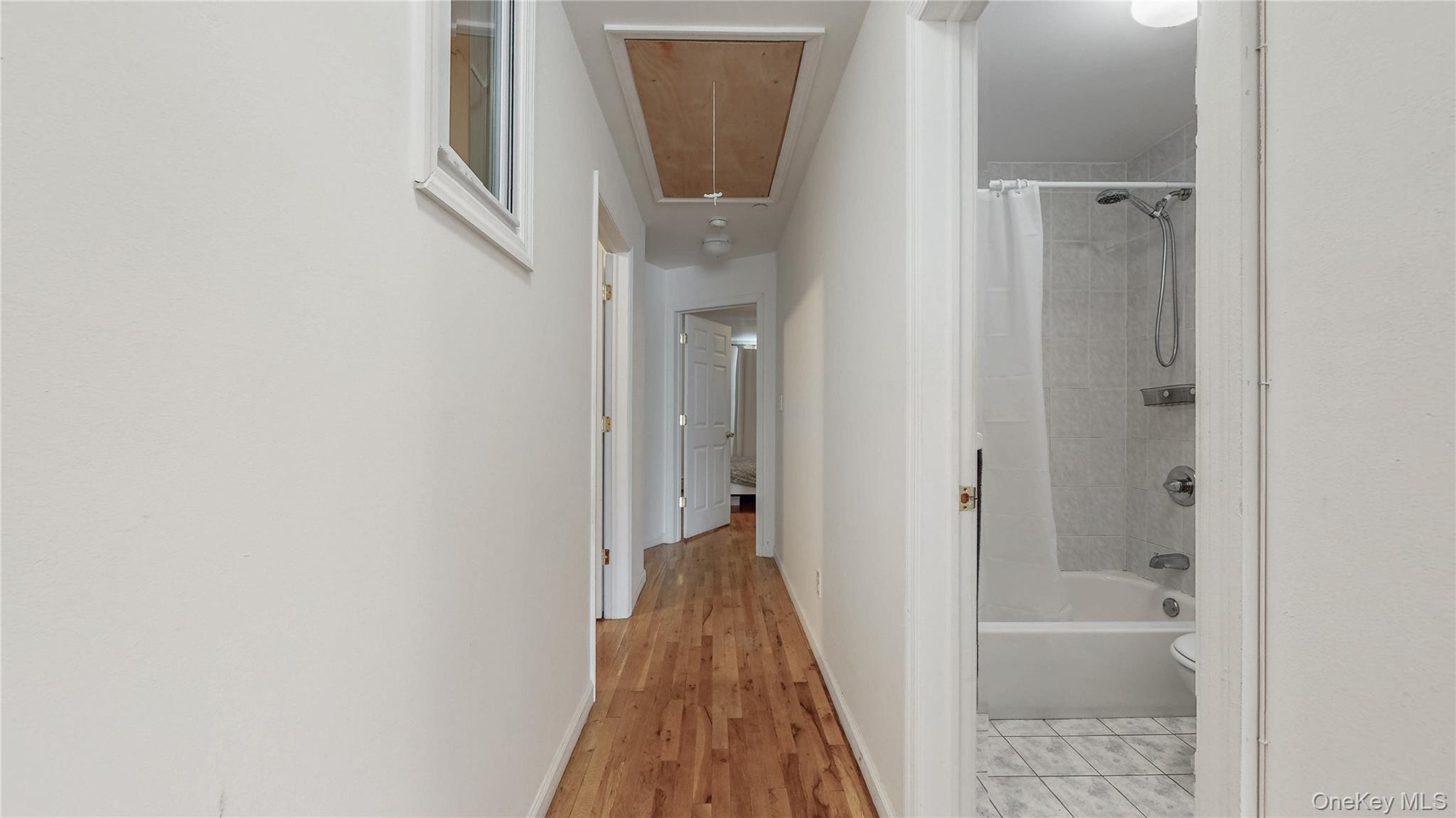 150-55 14th Road Queens, NY 11357 - Photo 15 of 39 a view of a hallway with wooden floor and a glass door