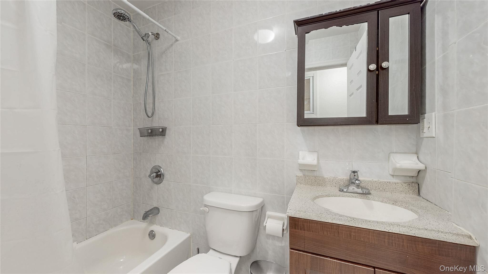 150-55 14th Road Queens, NY 11357 - Photo 16 of 39 a bathroom with a sink a toilet and shower