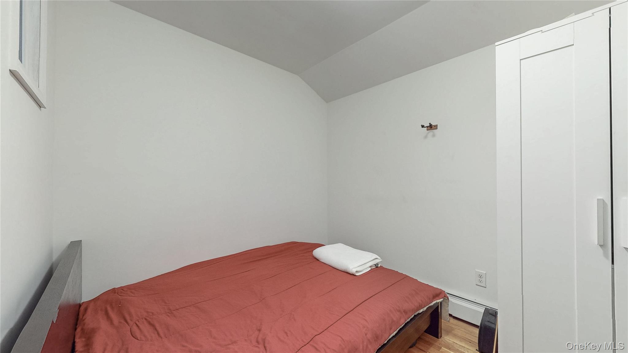 150-55 14th Road Queens, NY 11357 - Photo 17 of 39 a bedroom with a bed and a table
