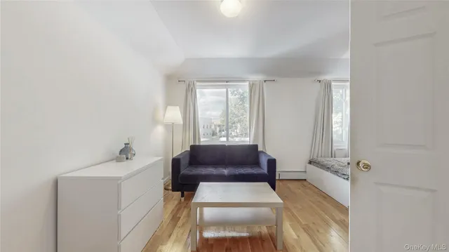 a hallway with a couch and a window