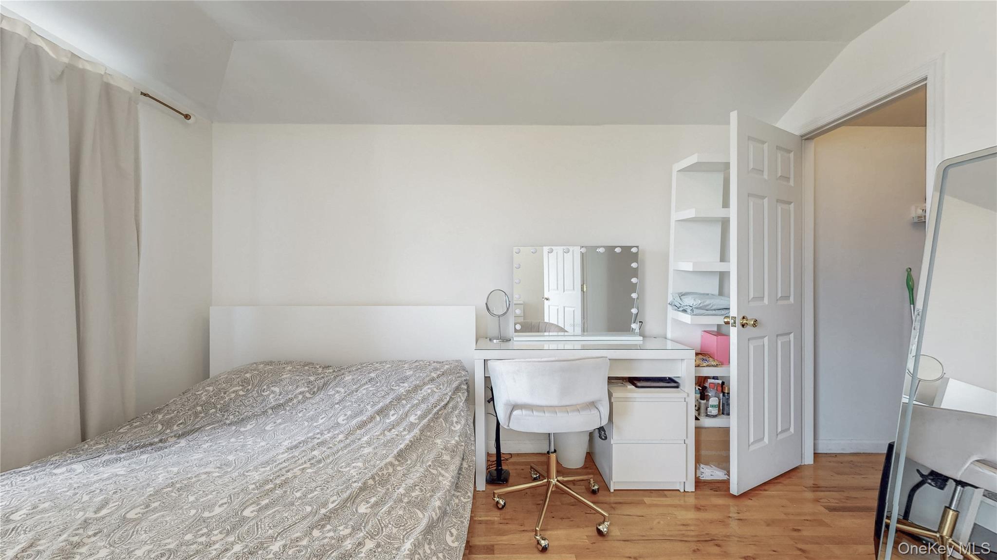 150-55 14th Road Queens, NY 11357 - Photo 19 of 39 a bedroom with a bed and a table in it