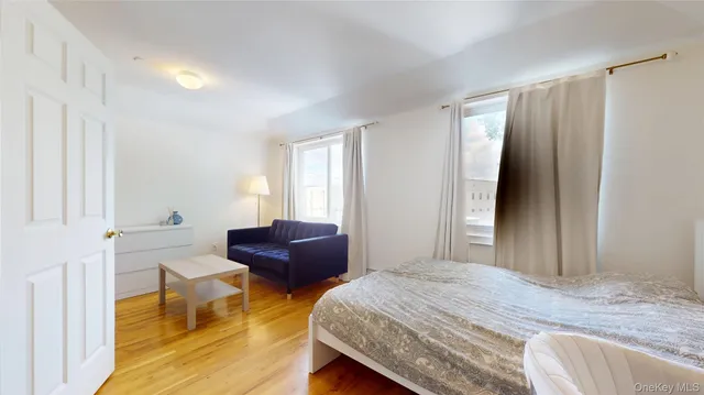 a bedroom with a bed and a couch