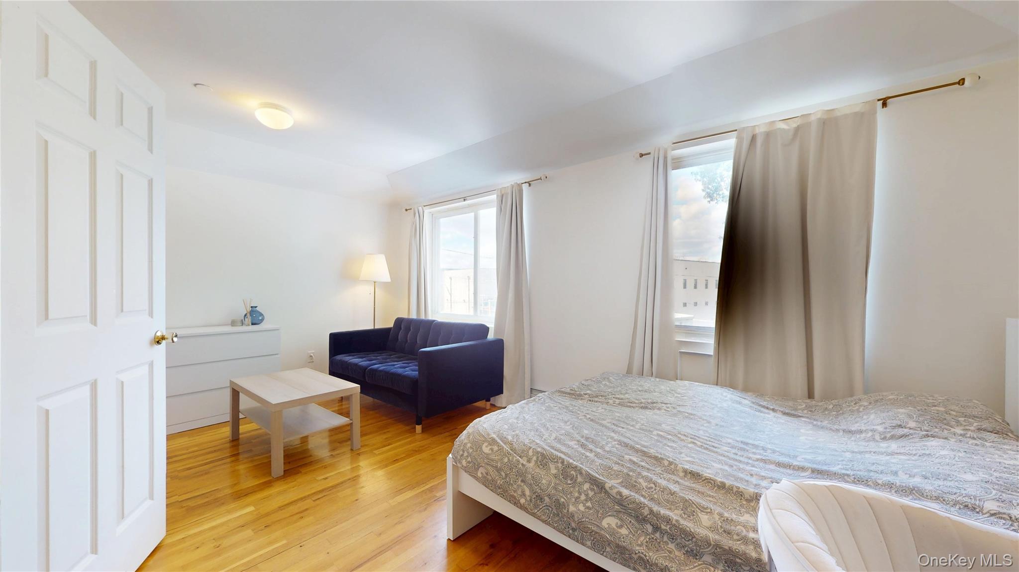 150-55 14th Road Queens, NY 11357 - Photo 20 of 39 a bedroom with a bed and a couch