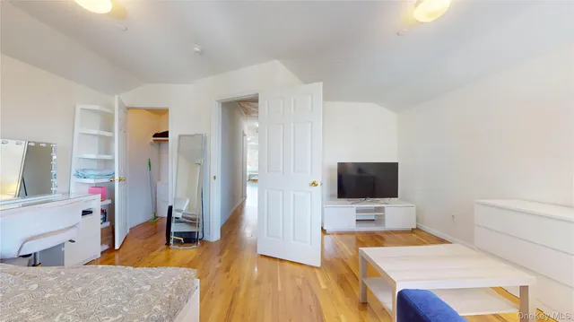 a bedroom with a bed and a flat screen tv