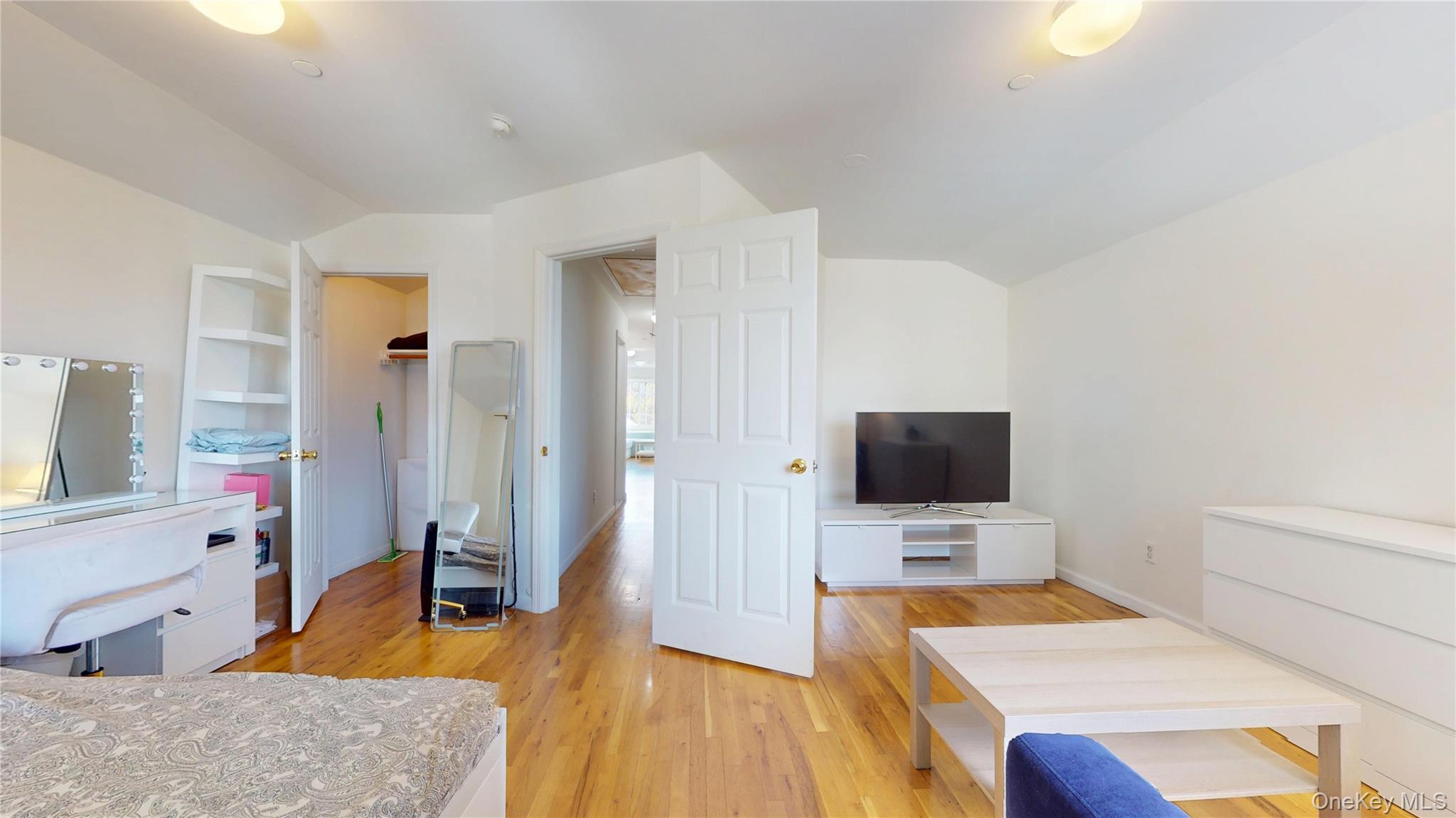 150-55 14th Road Queens, NY 11357 - Photo 21 of 39 a bedroom with a bed and a flat screen tv