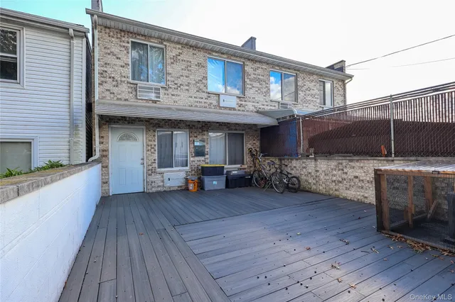 a view of a patio with table and chairs with wooden floor and fence