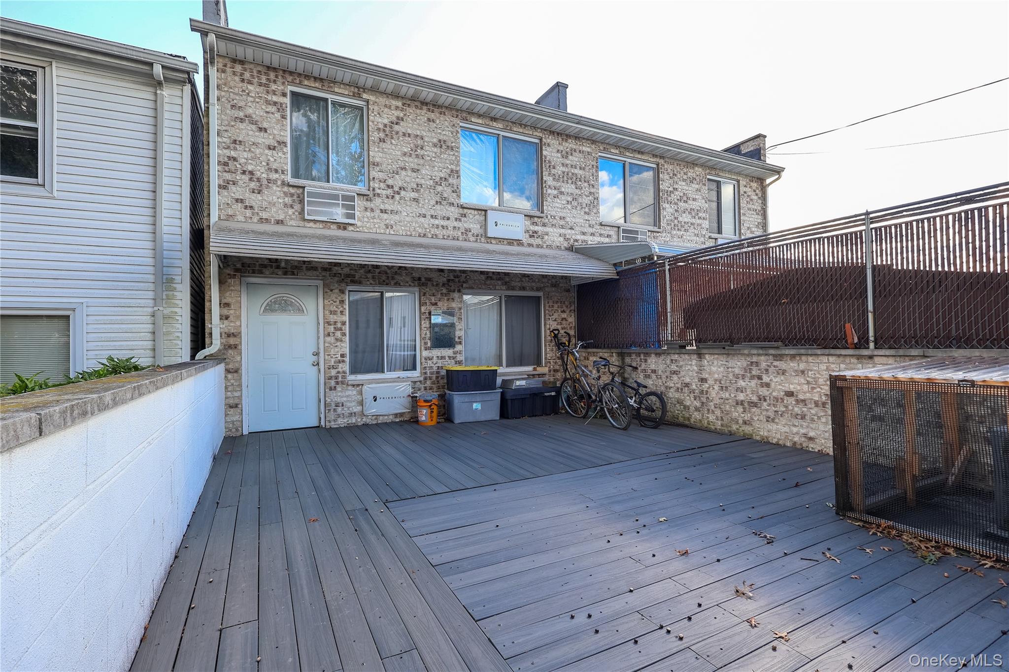 150-55 14th Road Queens, NY 11357 - Photo 33 of 39 a view of a patio with table and chairs with wooden floor and fence