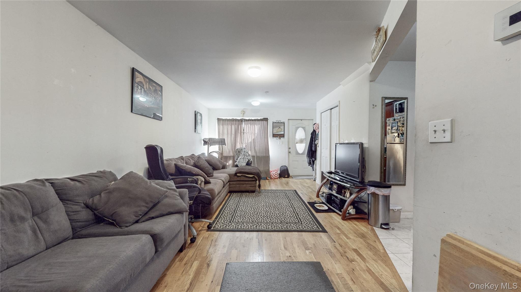 150-55 14th Road Queens, NY 11357 - Photo 4 of 39 a living room with furniture a flat screen tv and a table