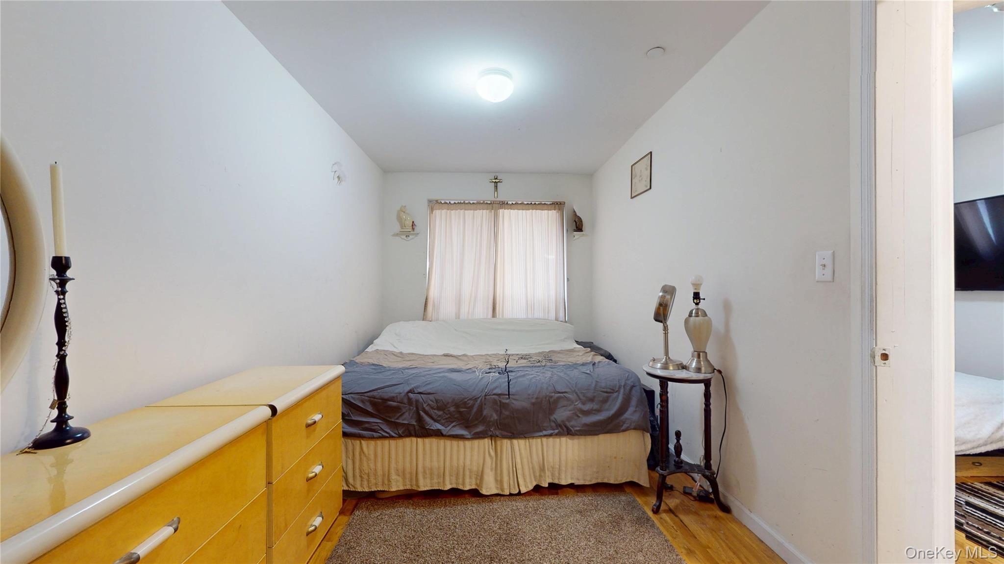 150-55 14th Road Queens, NY 11357 - Photo 8 of 39 a bedroom with a bed and a window