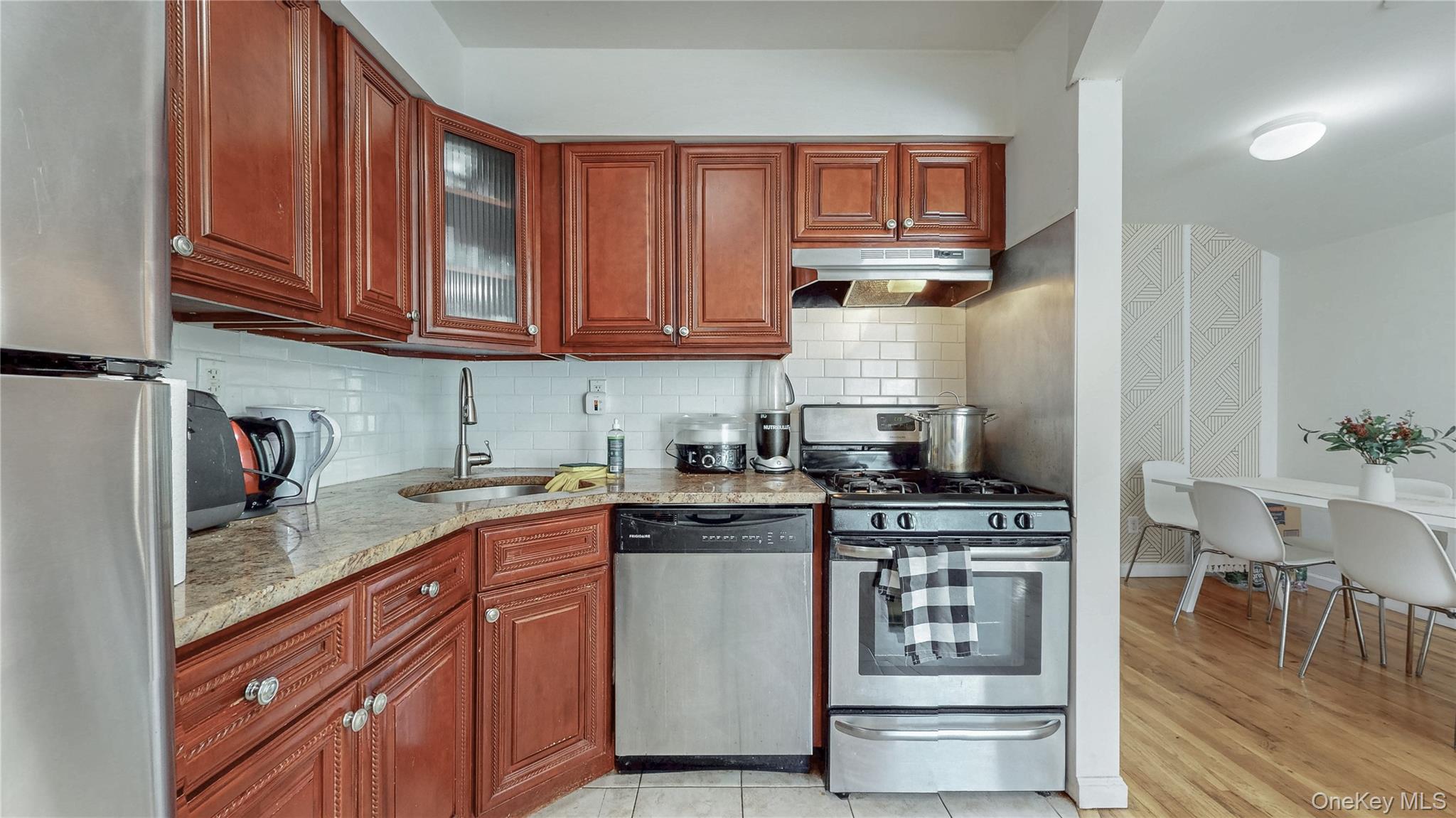 150-55 14th Road Queens, NY 11357 - Photo 10 of 39 a kitchen with stainless steel appliances granite countertop a stove and cabinets