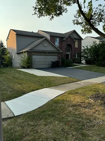 a front view of house with yard and green space