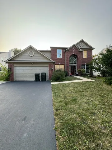 a front view of a house with a yard and garage