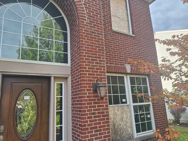 a front view of a house with large windows