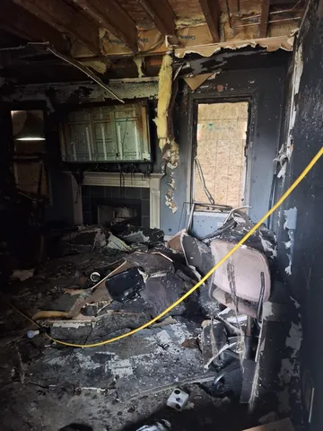 a room with water heater and wooden cabinets