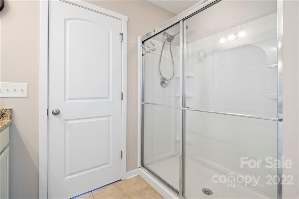 8218 Midas Lane Locust, NC 28097 - Photo 16 of 34 a bathroom with a glass shower door