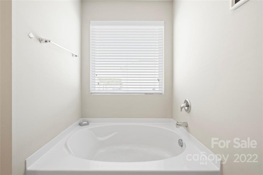 8218 Midas Lane Locust, NC 28097 - Photo 17 of 34 a white bath tub sitting in a bathroom