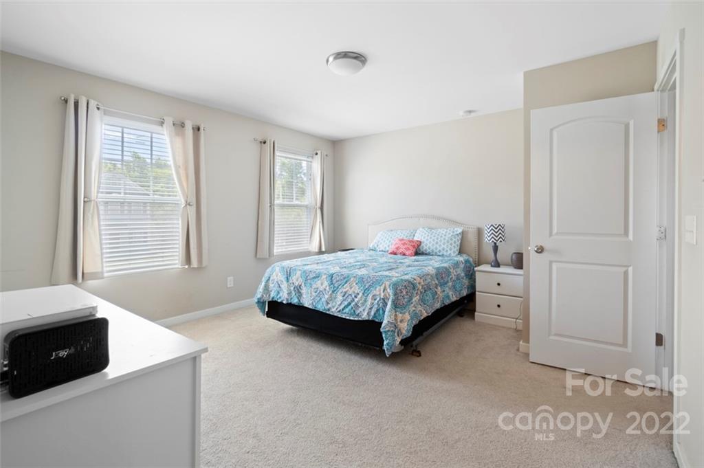 8218 Midas Lane Locust, NC 28097 - Photo 18 of 34 a bedroom with a bed and a cabinets