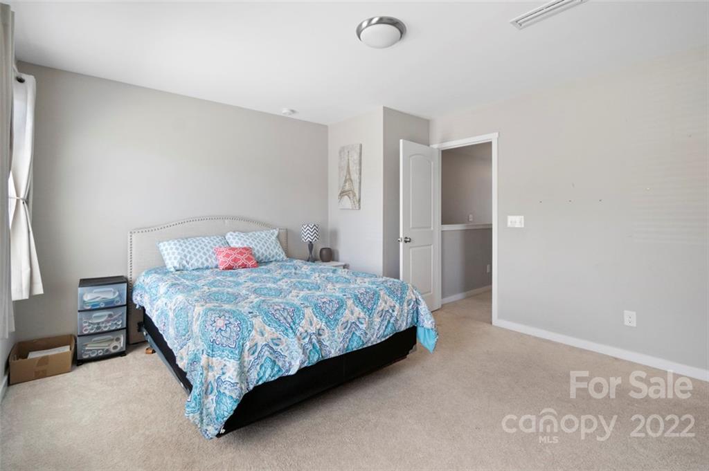 8218 Midas Lane Locust, NC 28097 - Photo 19 of 34 a bedroom with a bed and a cabinets