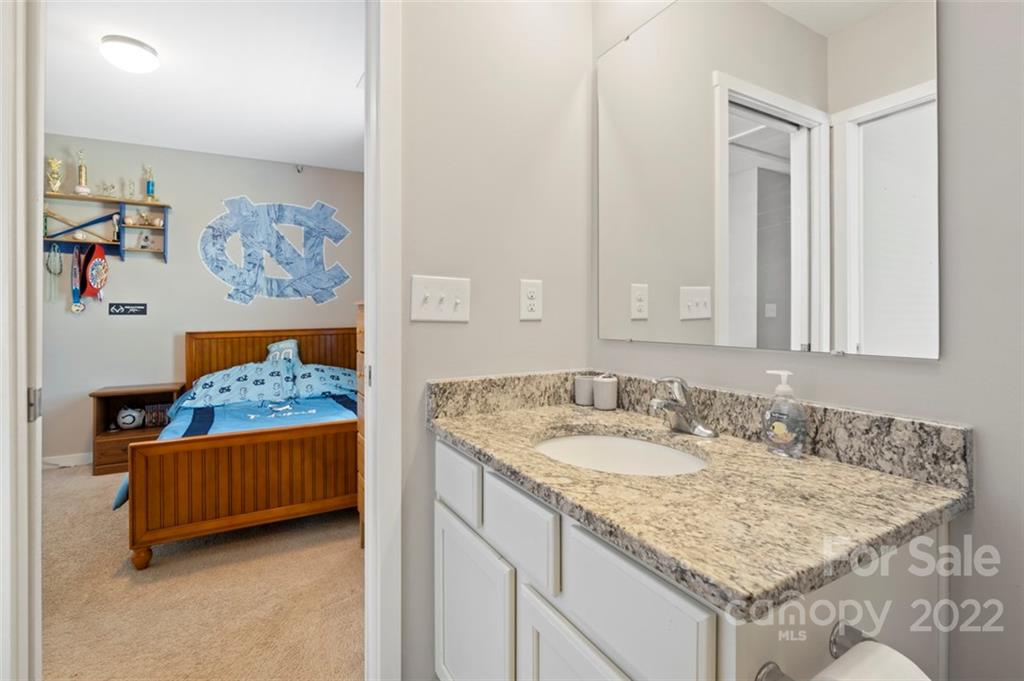 8218 Midas Lane Locust, NC 28097 - Photo 21 of 34 a bathroom with a granite countertop sink and a mirror