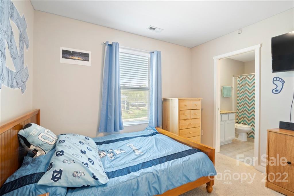 8218 Midas Lane Locust, NC 28097 - Photo 22 of 34 a bedroom with a bed and wooden floor