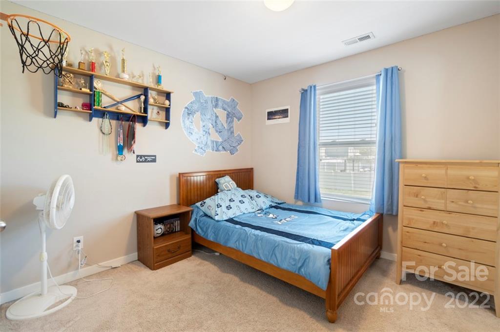 8218 Midas Lane Locust, NC 28097 - Photo 24 of 34 a bedroom with a bed and a window
