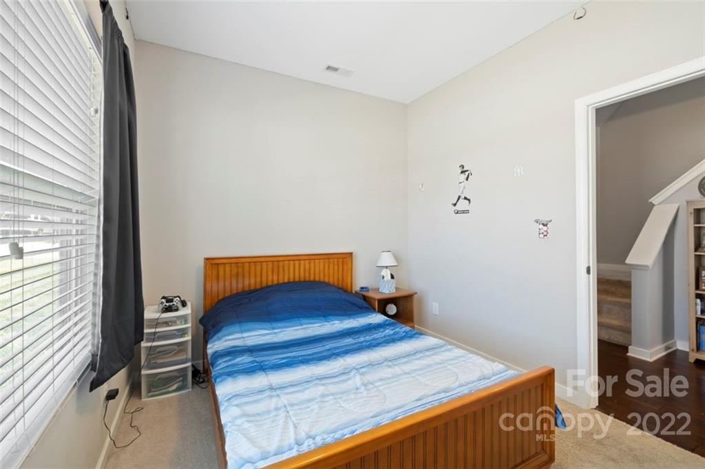 8218 Midas Lane Locust, NC 28097 - Photo 26 of 34 a bedroom with a bed and a window