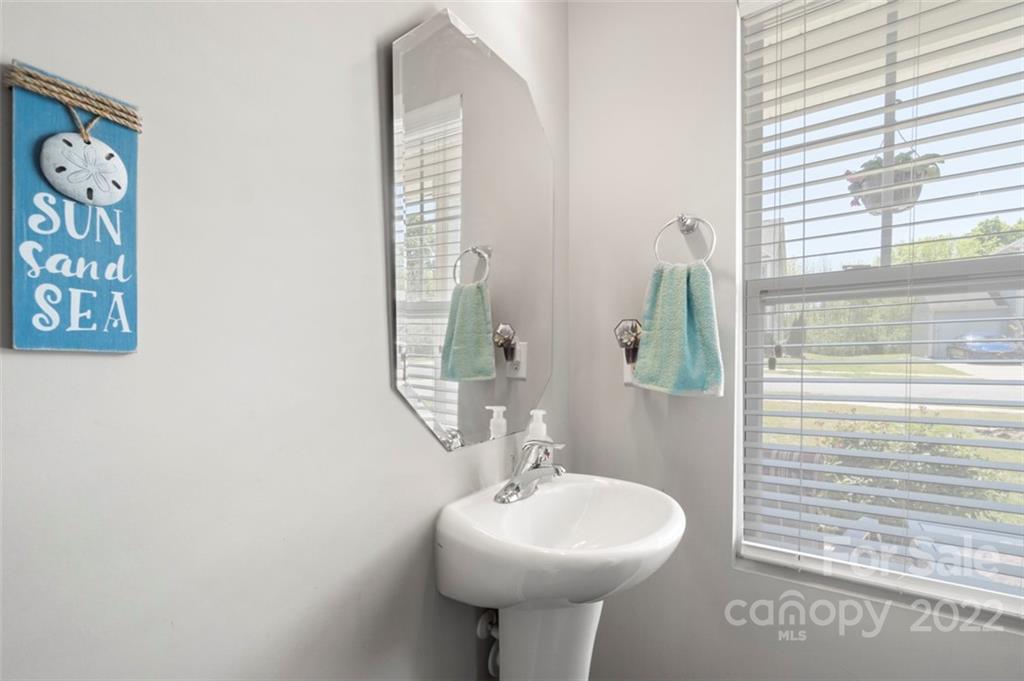 8218 Midas Lane Locust, NC 28097 - Photo 27 of 34 a bathroom with a sink a mirror and a window