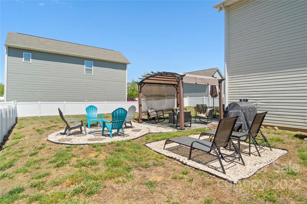 8218 Midas Lane Locust, NC 28097 - Photo 33 of 34 a view of a patio with table and chairs and potted plants
