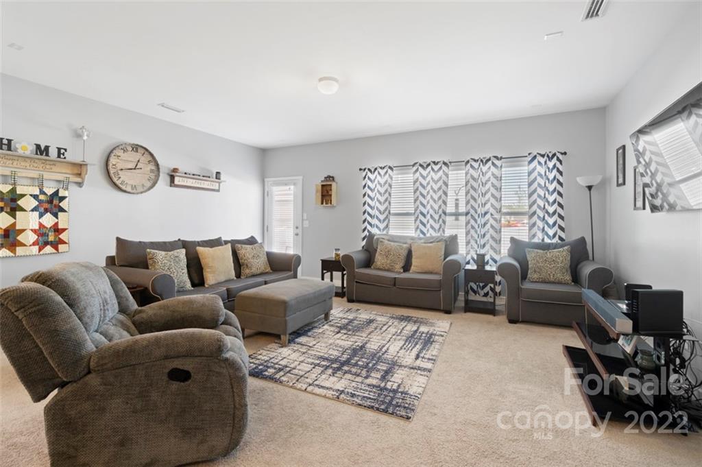 8218 Midas Lane Locust, NC 28097 - Photo 10 of 34 a living room with furniture and a large window