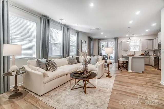 a living room with furniture and a wooden floor