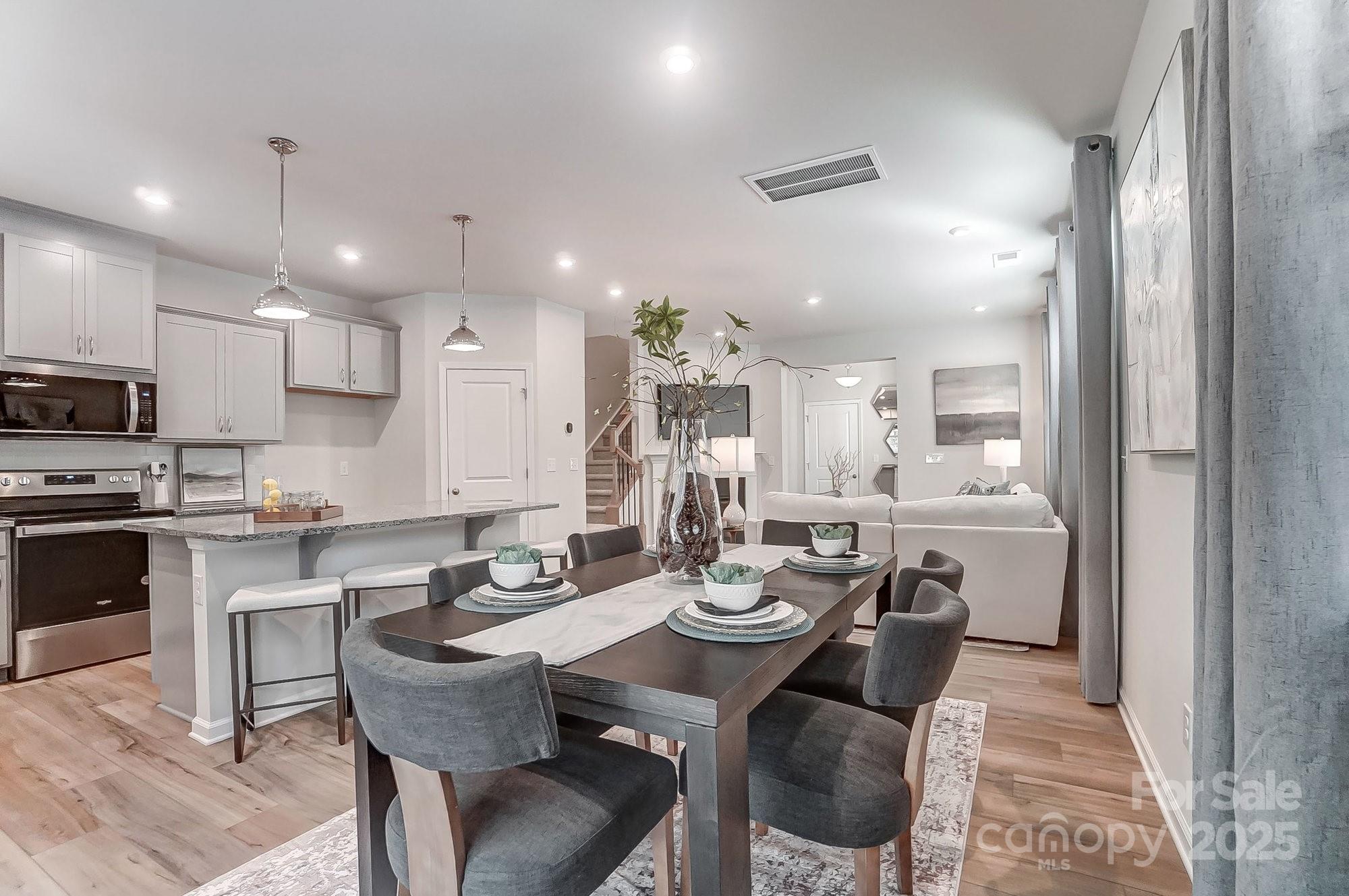 311 Laura Elizabeth Lane Clover, SC 29710 - Photo 14 of 39 a kitchen with a dining table chairs stove microwave and cabinets