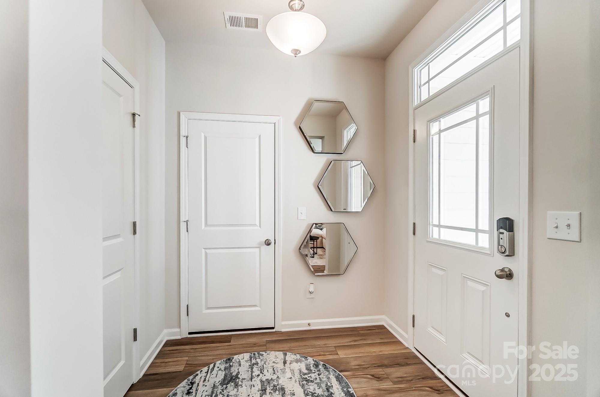 311 Laura Elizabeth Lane Clover, SC 29710 - Photo 5 of 39 a view of a entryway with wooden floor and mirror